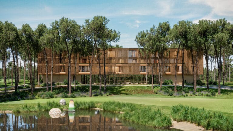 Modern low rise building with a wooden lattice facade nestled among tall pine trees on a golf course like lawn with water feature in the foreground