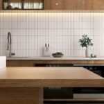 Modern kitchen with wooden island white tiled backsplash stainless steel faucet and built in oven