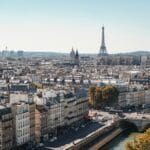 Paris cityscape with the Eiffel Tower in the distance river Seine and a stone bridge in the foreground