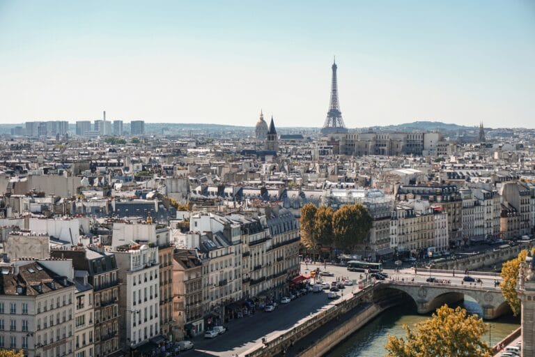 Paris cityscape with the Eiffel Tower in the distance river Seine and a stone bridge in the foreground