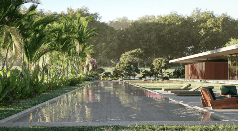 Long rectangular reflecting pool surrounded by tropical plants and lounge chairs at a modern outdoor retreat