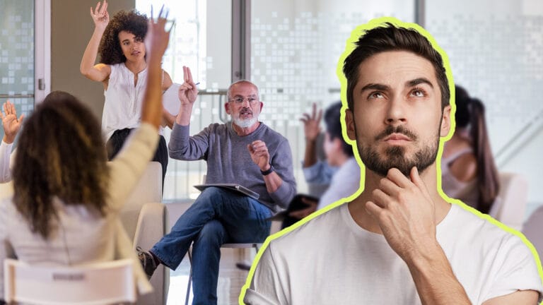Thinking man in foreground as diverse team raises hands in a bright office meeting behind him