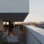 Modern outdoor balcony with a built in pool seating area and distant mountains at sunset