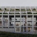 Modern apartment building facade with stacked balconies each filled with plants and patio furniture