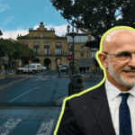 A man in a suit with glasses stands in a European town square a bright yellow outline marks a cutout overlay