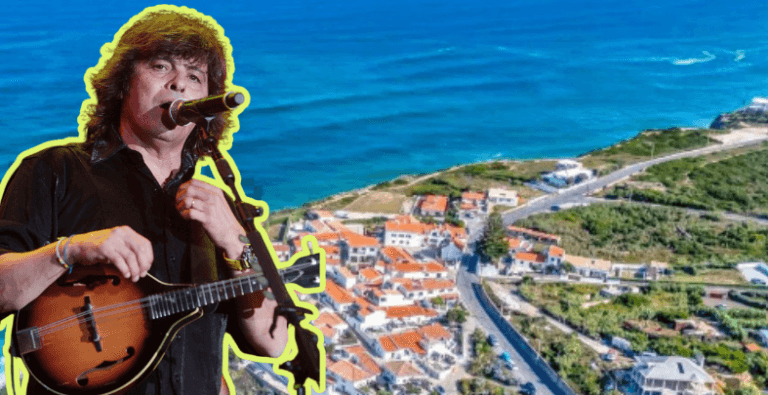 Musician singing and playing a guitar in front of an aerial coastal town backdrop