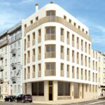 White modern corner building with curved wooden balconies on a sunny urban street scene