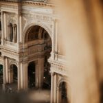 Galleria Vittorio Emanuele II in Milan grand arched arcade with ornate columns and reliefs viewed from above