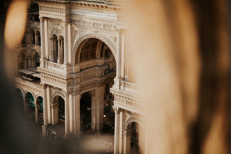Galleria Vittorio Emanuele II in Milan grand arched arcade with ornate columns and reliefs viewed from above